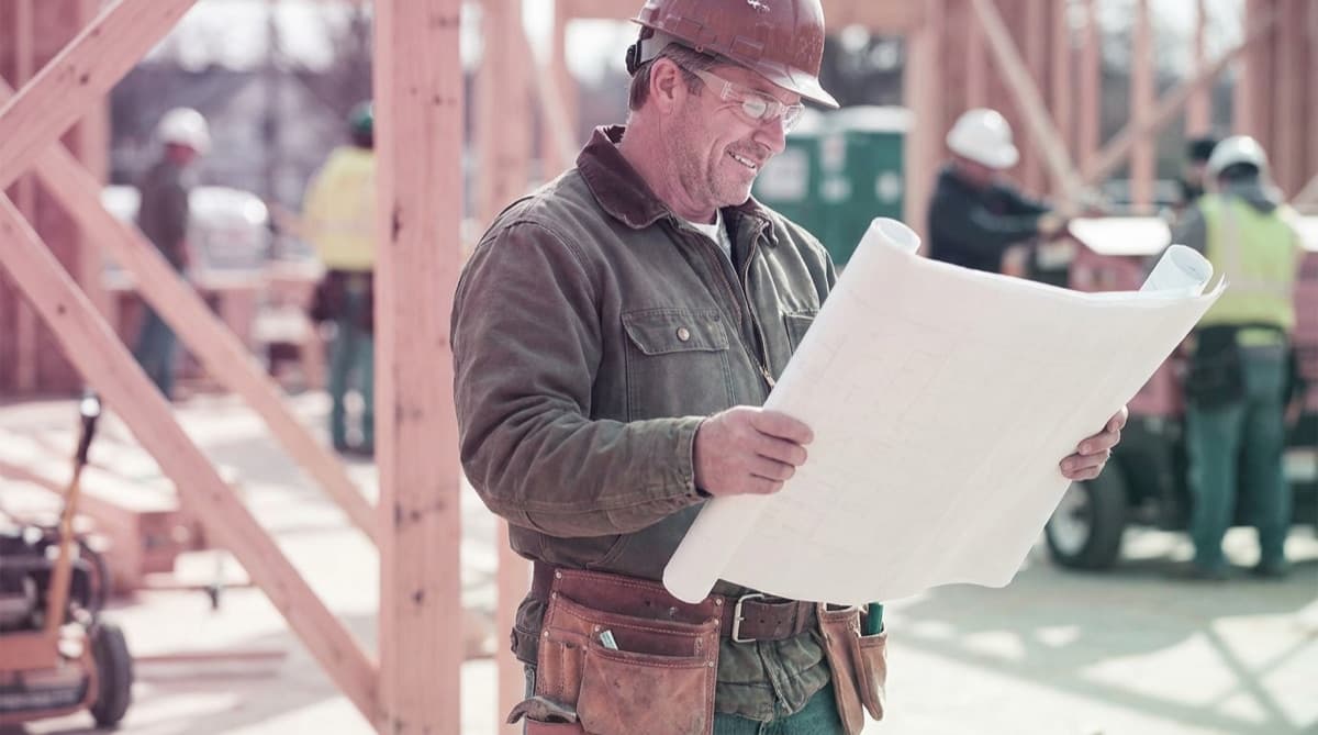 Construction site with workers reviewing plans