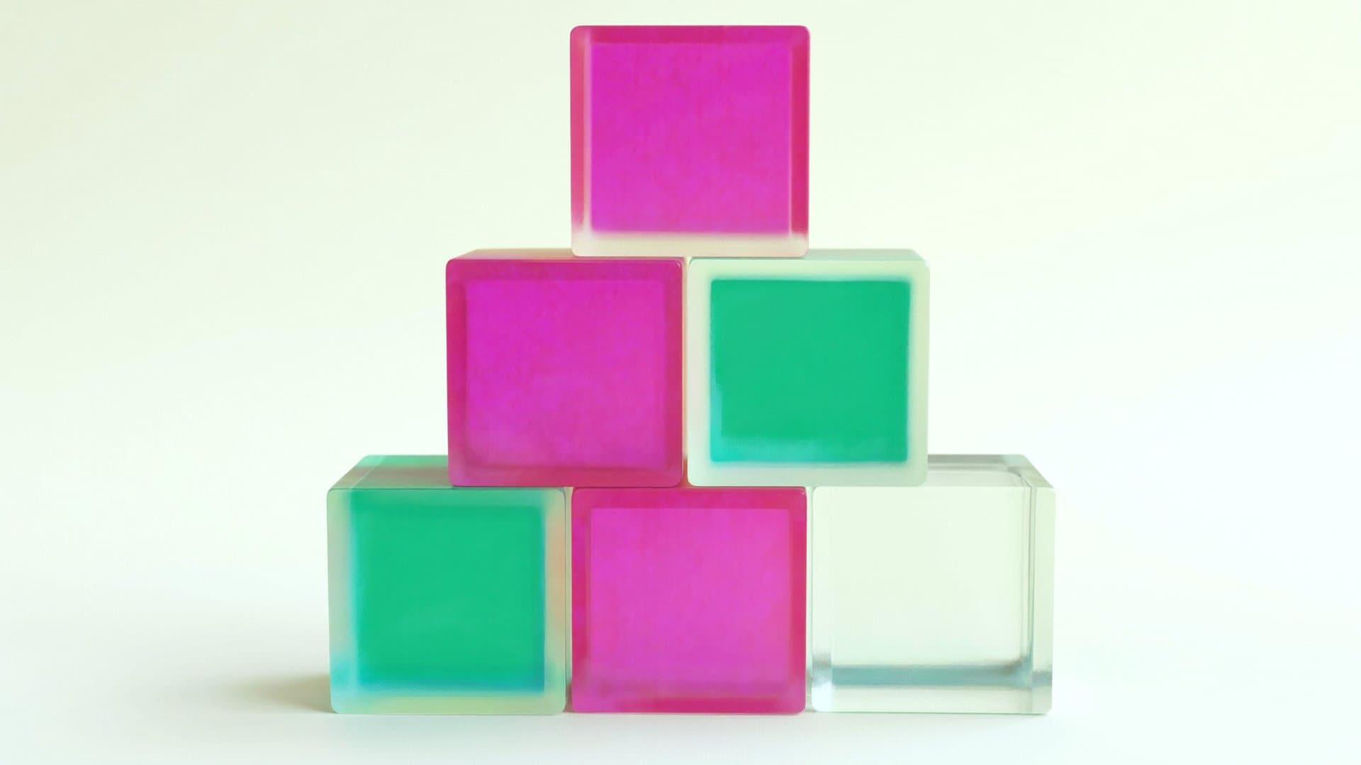 A tidy pyramid of frosted glass cubes in magenta pink, emerald green, and clear frost on a pale mint-cream field — stock stacked and funded before it sells