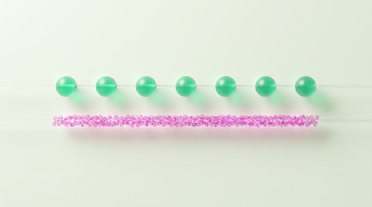 Seven calm evenly spaced green beads above a crowded string of tiny pink beads — weekly versus daily remittance